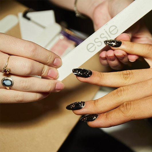 nails being filed by a manicurist into an oval shape