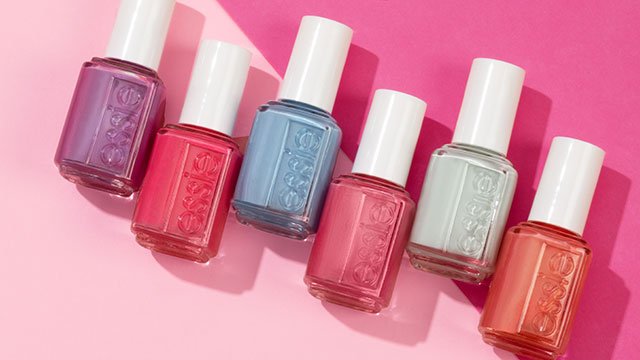 The 6 blushin' & crushin' shades arranged laying in a zigzig line on a light and dark pink background