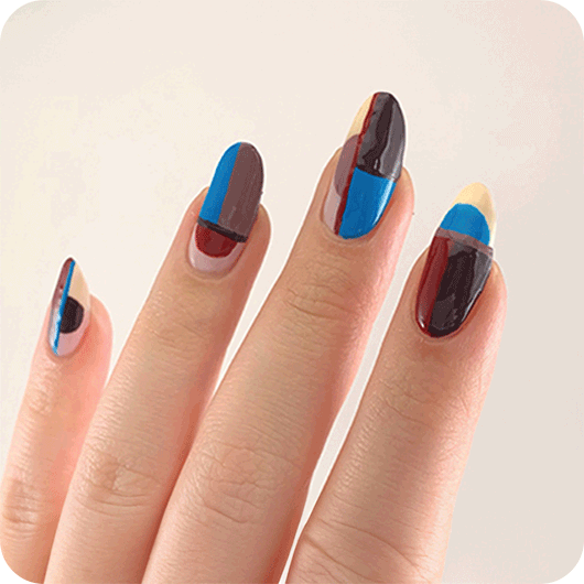 Close-up of a light skin hand featuring nail art created with essie odd squad nail polish shades