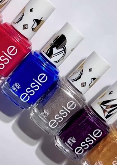 Array of nail polish bottles from the essie x Disney's Snow White collection against a white background