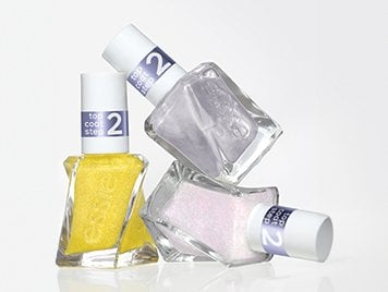 Three bottles of metallic glazed topcoats arranged in a pile against a white background