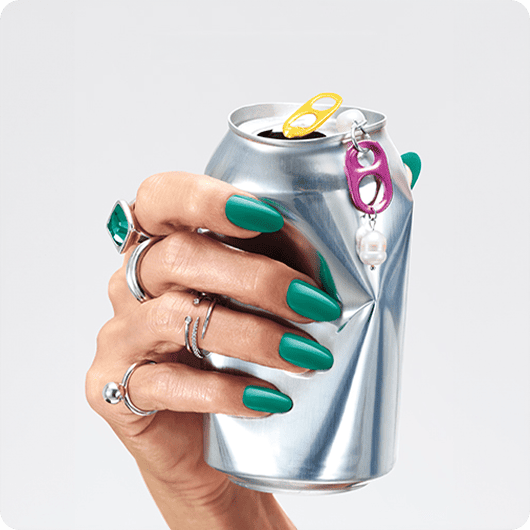 hand with nails in the shade dopamine rush crushing a soda can